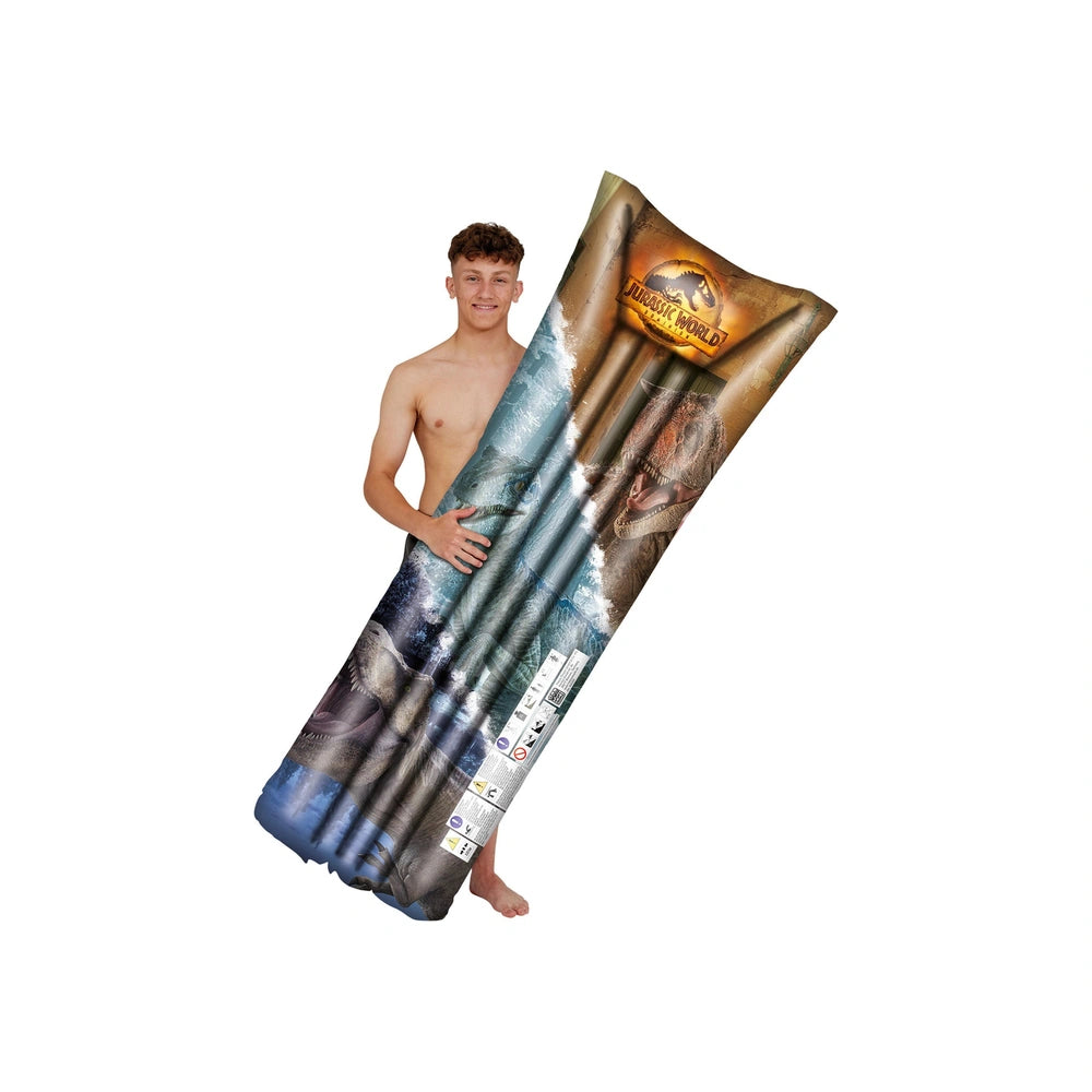 Jurassic World air mattress, cylindrical with vibrant blue, green, and brown printed design, displayed by a young man.