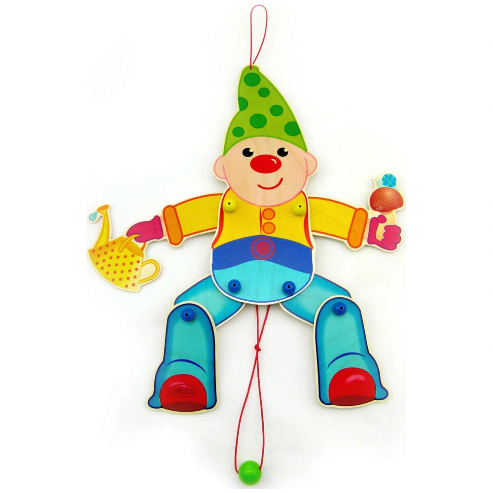Hess Jumping Jack Dwarf toy features a green face, striped yellow shirt, blue pants, and colorful fabric hat and gloves.
