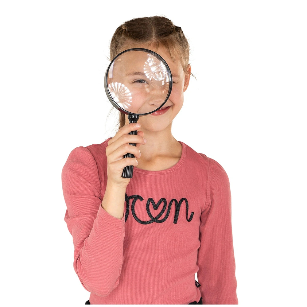 Johntoy Science Explorer Magnifying Glass held by a girl in a pink shirt, featuring a black handle and clear lens.