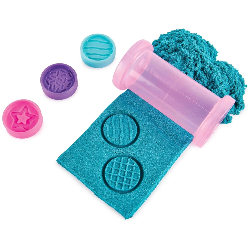 Kinetic Sand Unicorn Bake Shoppe set includes colorful plastic toys like a pink tube and blue mat with circular cutouts.