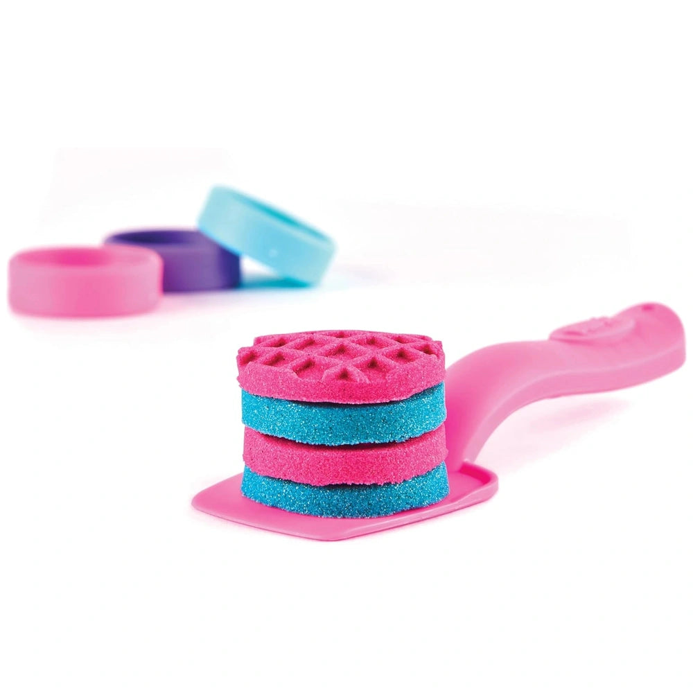 Kinetic-Sand Unicorn Bake Shoppe features a pink hairbrush with a wavy handle and soft bristles for gentle hair care.