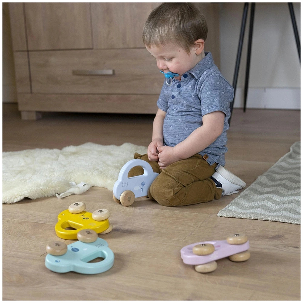 Label-Label Little Car push and pull toy in blue and yellow, with a child in a blue shirt and brown pants playing on wooden f