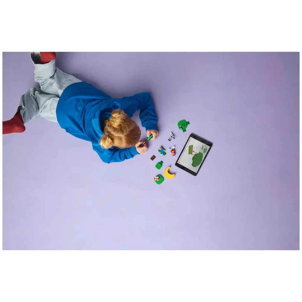 Lego - Animal Crossing - Stargazing with Celeste set features a child in blue clothing lying on a purple surface, holding a c