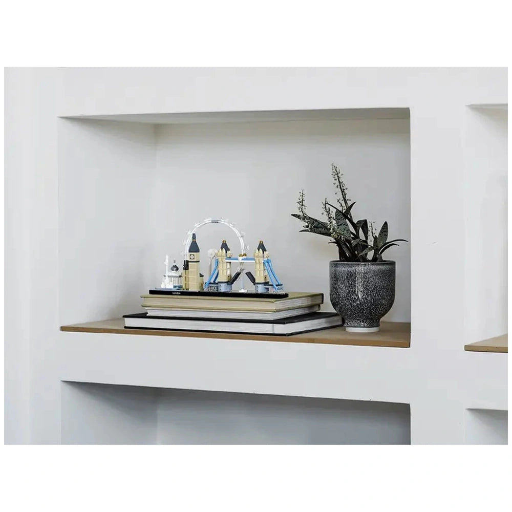 LEGO Architecture London set displayed on a shelf, featuring iconic landmarks like Big Ben and Tower Bridge, surrounded by stacked books and a potted plant.