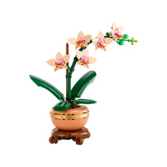 Delicate LEGO® Mini Orchid set with five peach blooms and green leaves, displayed in a light terracotta pot on a wood-effect base.