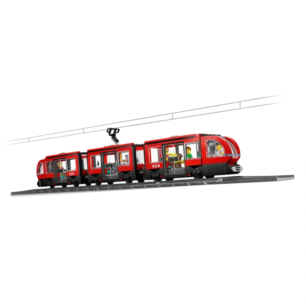 LEGO® City Downtown Streetcar features a vibrant red design with multiple passenger windows, showcasing minifigures inside, set on a black rail.