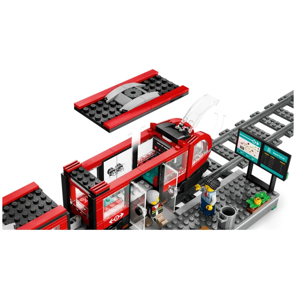 LEGO® City Downtown Streetcar in vibrant red with open double doors, accompanied by a detailed station, minifigures, and tracks.