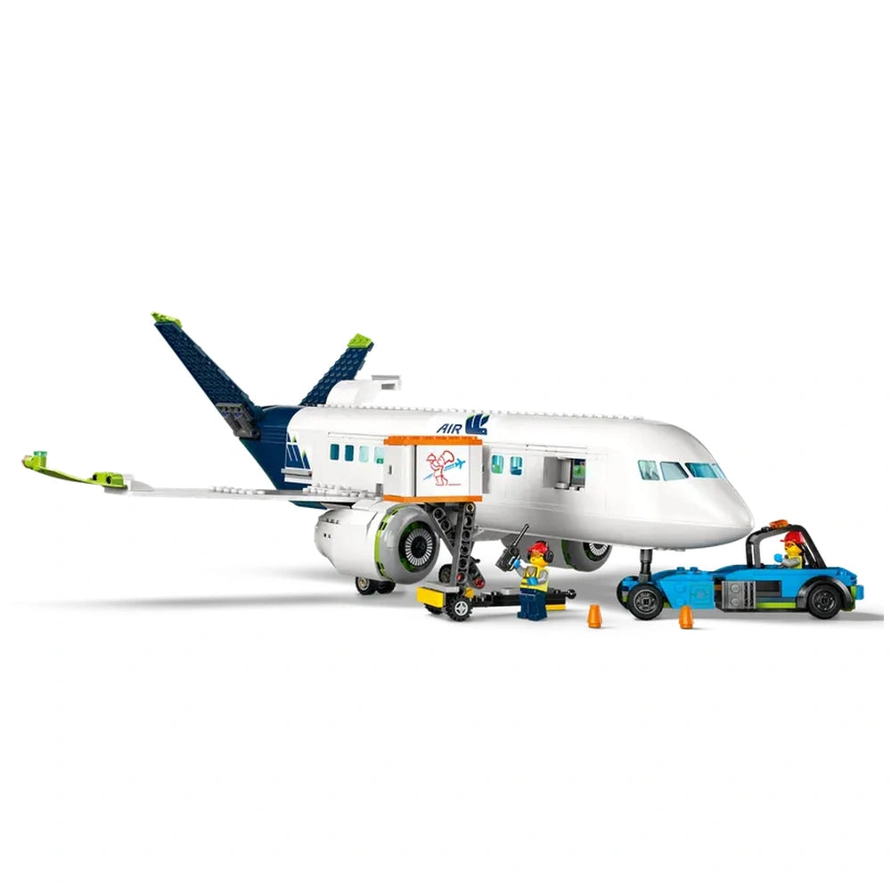 LEGO® City Passenger Airplane set featuring a detailed aircraft model with vibrant blue and white colors, surrounded by minifigures, catering truck, and pushback tug.