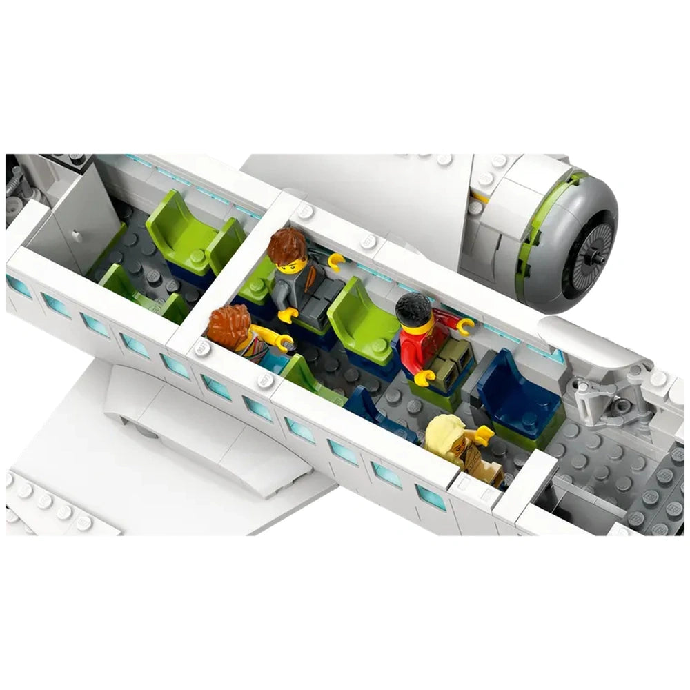 Lego City Passenger Airplane interior showing two green and blue seats, four minifigures, and detailed cabin elements like a cockpit area.