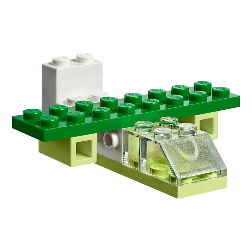 Colorful green and white LEGO bricks arranged in a creative build, featuring transparent elements and a compact design.