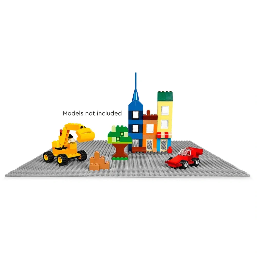 Gray LEGO® Classic Baseplate with colorful building models, including a yellow construction vehicle, a green tree, and a red car.