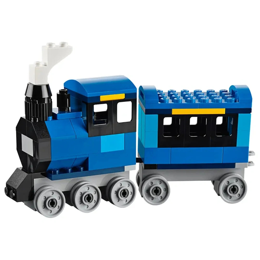 A vibrant blue LEGO train with a black smokestack and gray wheels, featuring a passenger car attached, designed for creative building play.