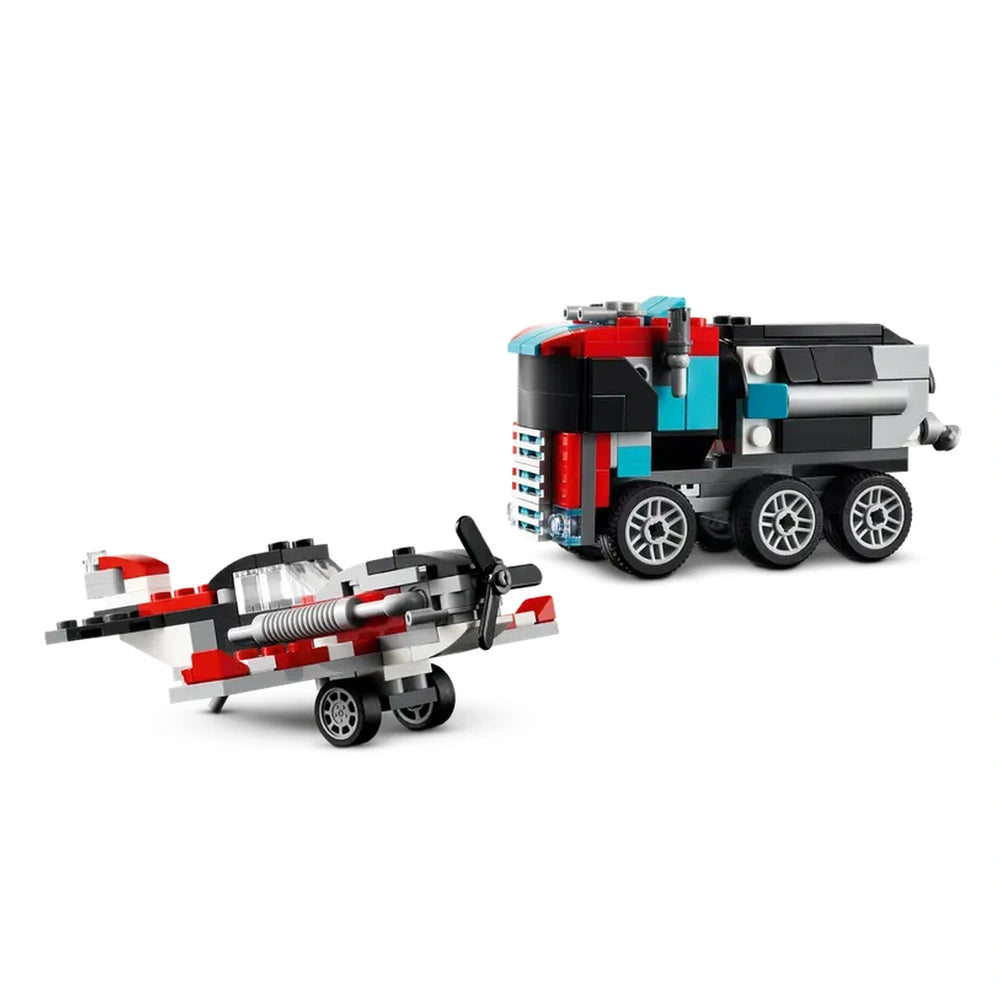 LEGO Creator Flatbed Truck in black and red beside a helicopter in grey and red, showcasing wheels and moving parts.