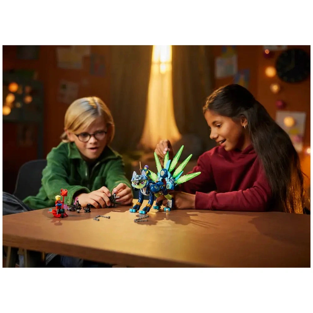 Two children play with LEGO® DREAMZzz™ set, assembling Zian the Cat-Owl with vibrant wings and colorful accessories on a table.