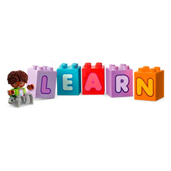 Colorful LEGO® DUPLO® bricks spell "LEARN," accompanied by a cheerful toddler figure with curly hair, ready for creative play.