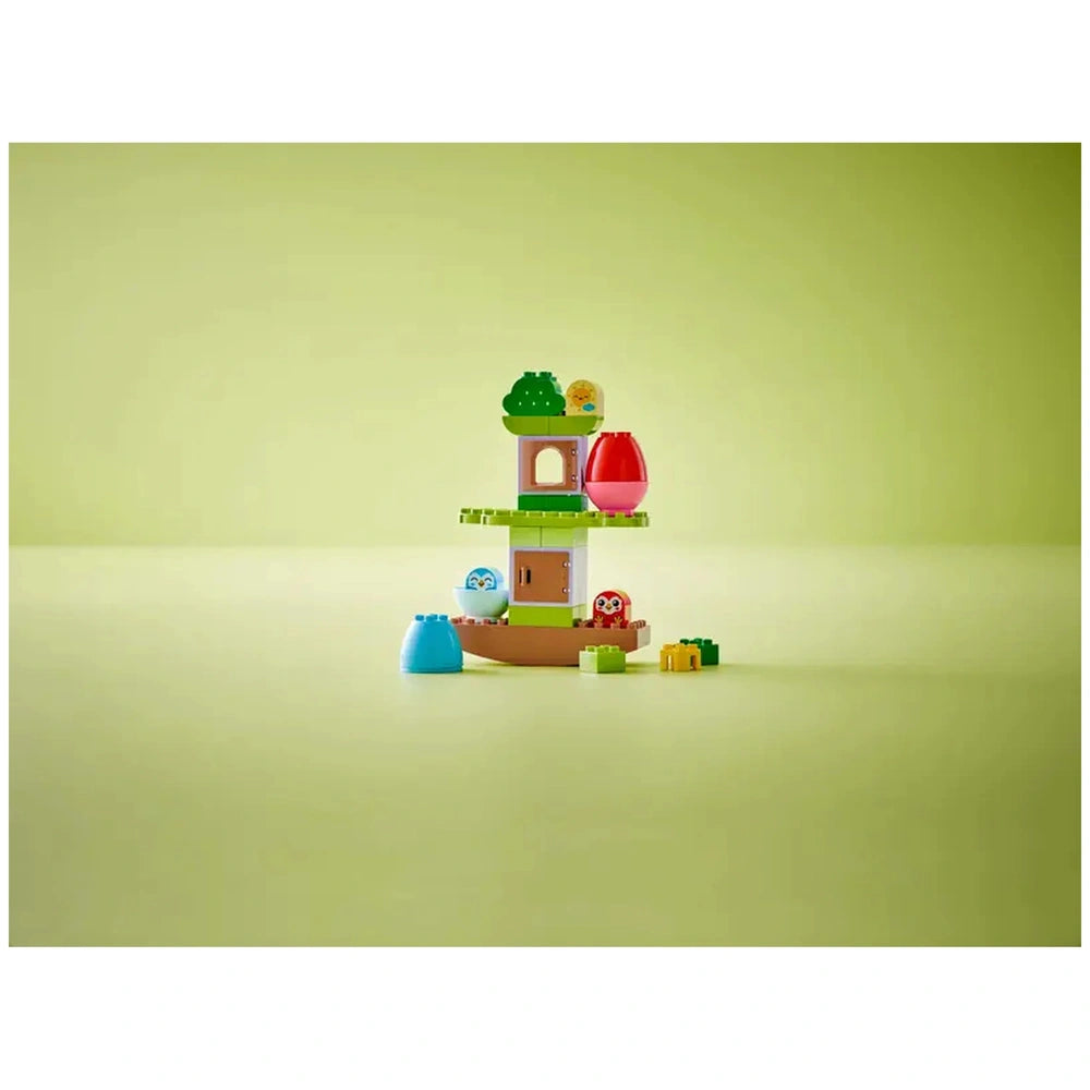 Colorful LEGO® DUPLO® Balancing & Stacking Tree set, featuring a treehouse, adorable owl figures, and playful stacking elements on a light green background.