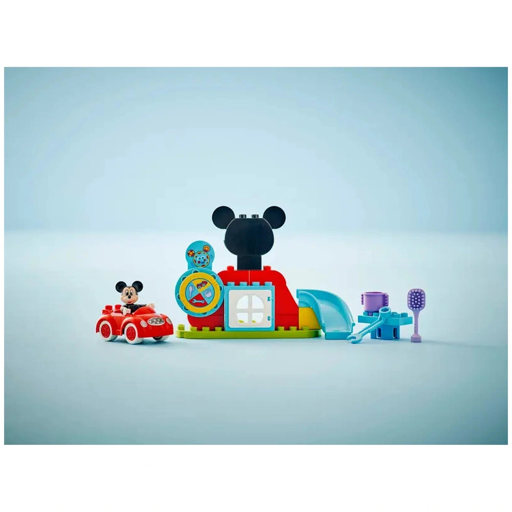 LEGO® DUPLO® Mickey Mouse Clubhouse set featuring a colorful building structure with a large Mickey Mouse face, a red toy car, and various accessories for interactive play.
