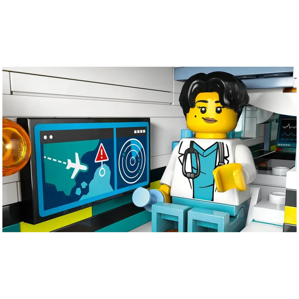 A LEGO minifigure of a doctor sits in a medical lab inside the Emergency Air Ambulance, next to a digital control panel displaying flight data.