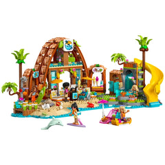 Colorful LEGO Family Vacation Beach Resort construction set featuring six minidolls, a dolphin, and a turtle. The scene showcases a vibrant pool, slide, lounge area, and various beach activities, encouraging imaginative play and family fun.