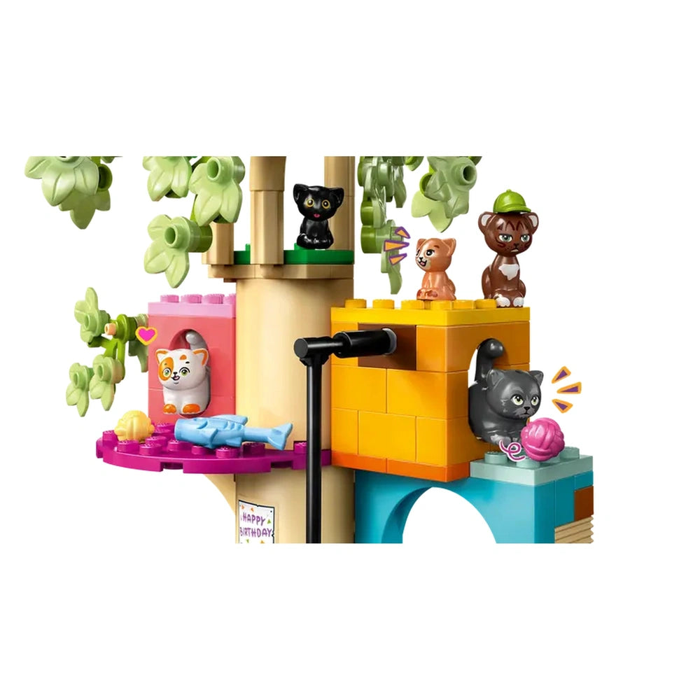 Colorful LEGO Friends set featuring Churro the cat's birthday party, with minidolls and playful cat figures around a vibrant tree house.