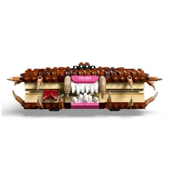 LEGO Harry Potter Chomping Monster Book of Monsters set features a brick-built monster book with a furry cover, large white teeth, and fangs, showcasing intricate details in brown, pink, and cream colors. The design includes playful eyes and jagged spikes, perfect for imaginative play and fans of the Harry Potter series.
