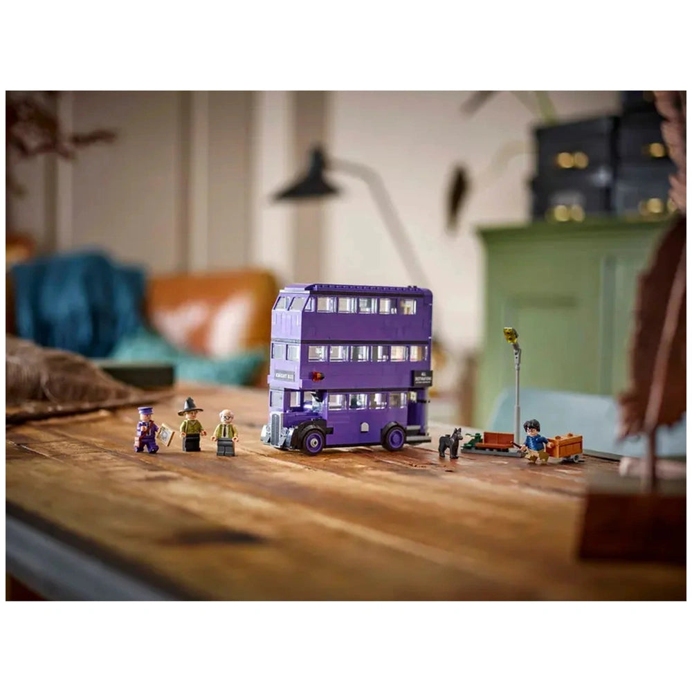 LEGO Harry Potter Knight Bus set showcased on a wooden table, featuring a detailed purple triple-decker bus and four minifigures.