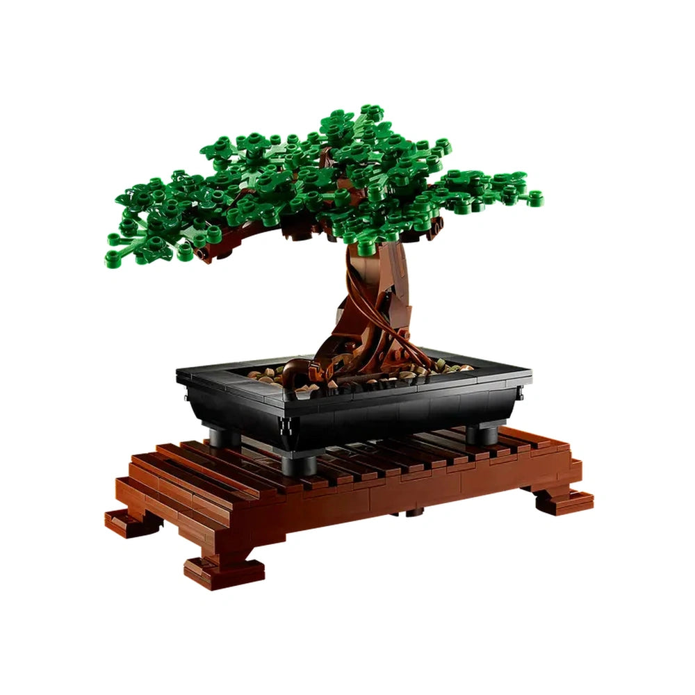 LEGO® Icons Bonsai Tree set featuring lush green leaves, intricately designed branches, and a black pot resting on a wooden base.