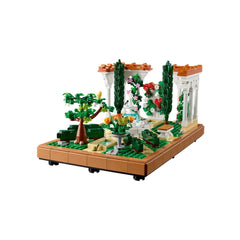 A vibrant LEGO® Icons Fountain Garden with a tiered fountain centerpiece, surrounded by greenery, flowering vines, and ornamental structures.