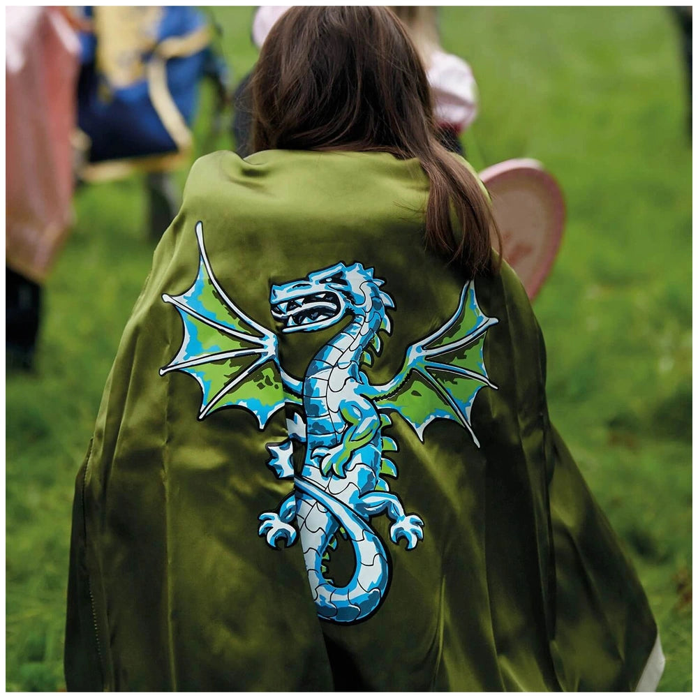 Liontouch Dragon Shield cape in green with a glossy blue dragon emblem featuring open eyes and visible teeth, worn by a perso