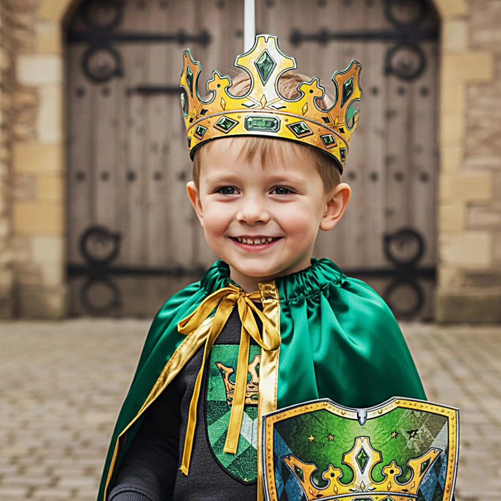 Liontouch Kingmaker Sword held by a child in a green cape, gold sash, and a yellow-green crown in front of a wooden door.