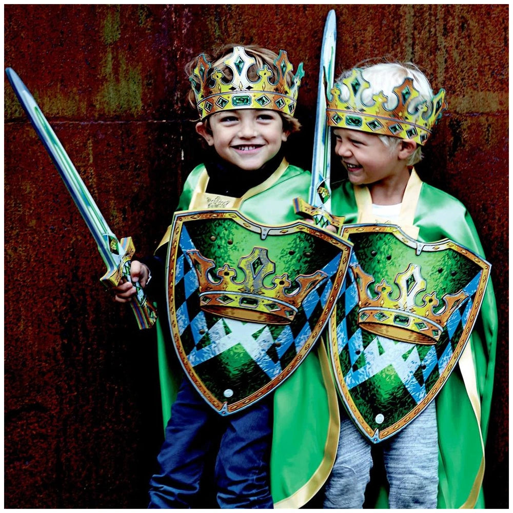 Liontouch Kingmaker Sword held by two children in metallic sheen costumes with crowns, against a rusted metal wall backdrop.