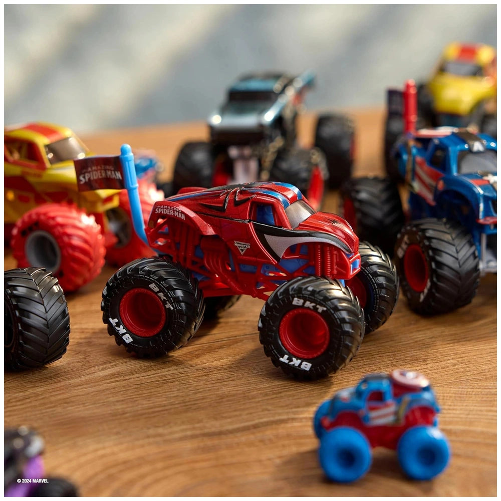 Monster Jam truck toys in red and blue with textured and smooth wheels arranged on a light brown wooden surface.