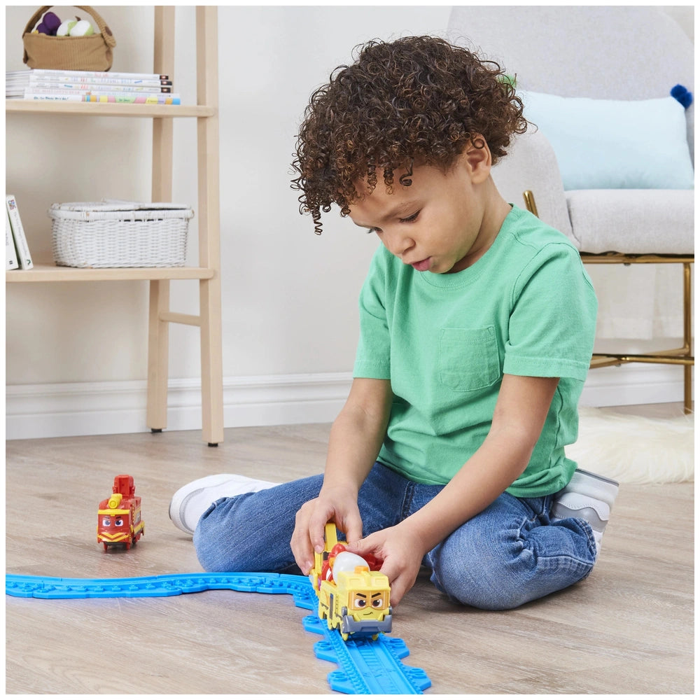 Mighty Express Motorized Train set with a child in a green shirt playing on hardwood floor surrounded by a cozy indoor settin