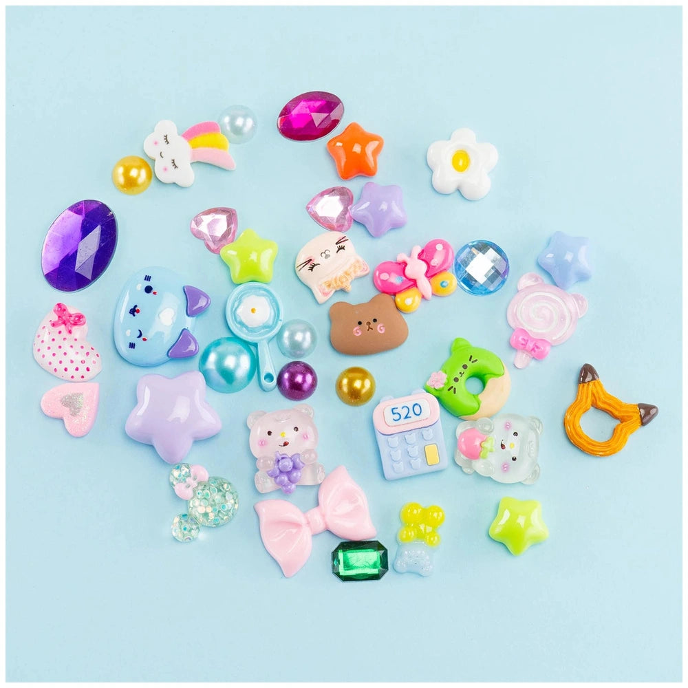 Momomi Decoden Kawaii Artist creamy mirror and brush featuring colorful heart, star, and animal shapes in plastic and rubber.