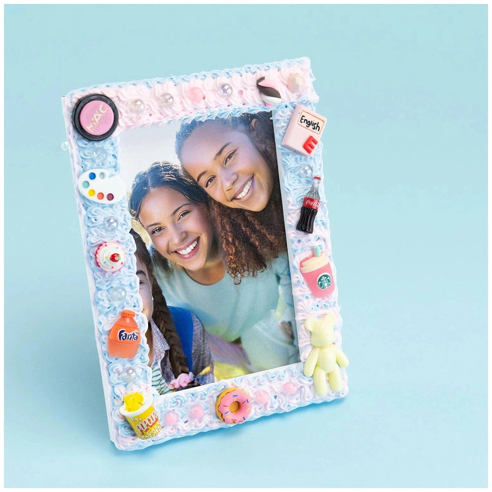 Momomi Decoden Kawaii Artist Creamy Phone Cover featuring colorful paint tools on a light blue background, held by two people