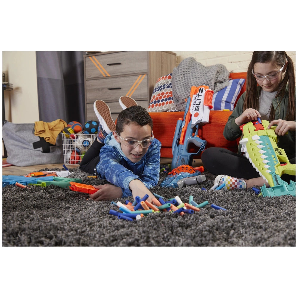 Nerf Elite 2.0 Shockwave RD-15 Blaster displayed on a wooden floor with two people playing in a colorful living room setting.
