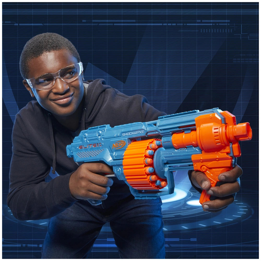 Nerf Elite 2.0 Shockwave RD-15 Blaster held by a smiling person in a black hoodie and safety goggles against a dark grid back