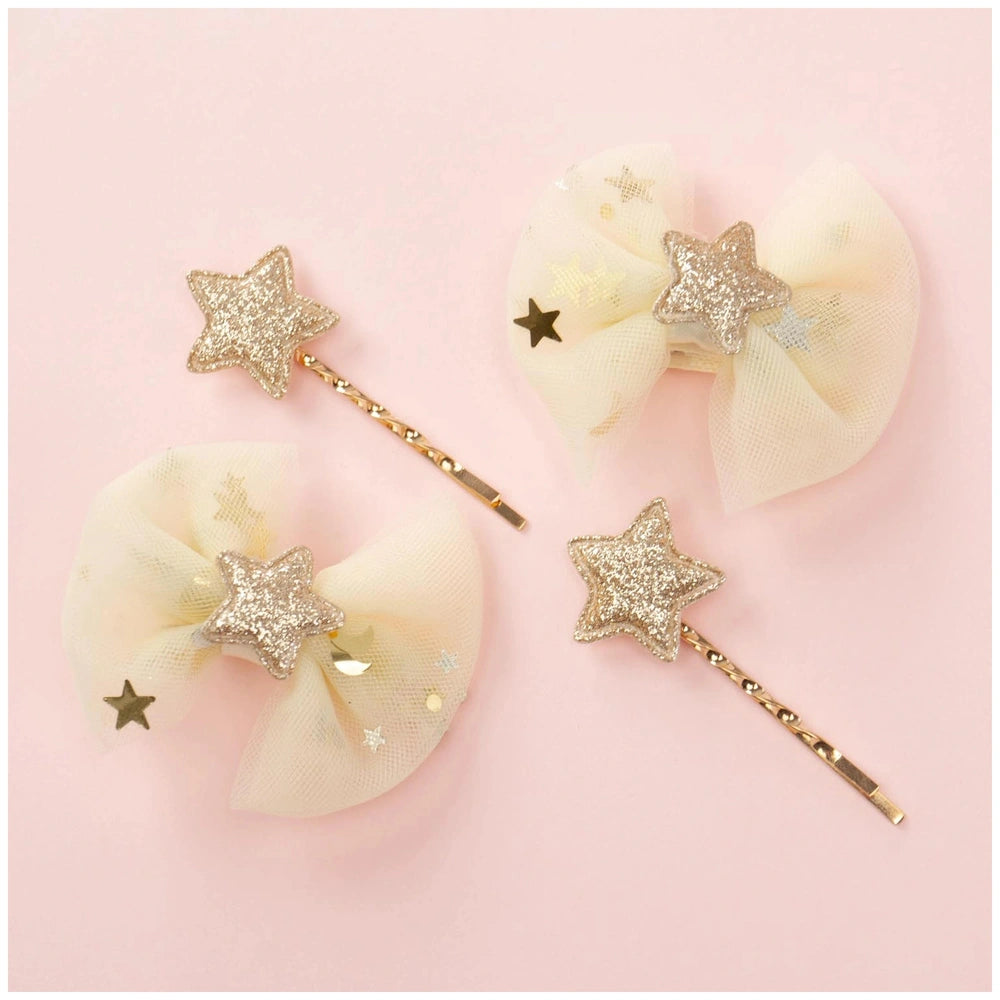 Classy ribbon hair clip set featuring two white glossy bows with glittery gold and silver star elements on a light pink backg