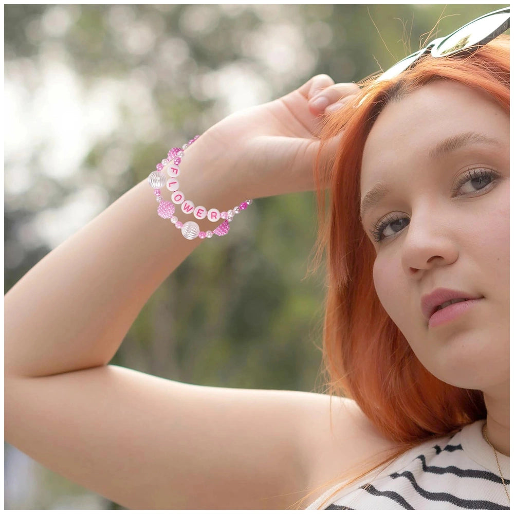 Crea-ABC-Beads-Flower-Bouquet kit showcased by a woman with red hair, wearing a striped top and a pink and white bead bracele