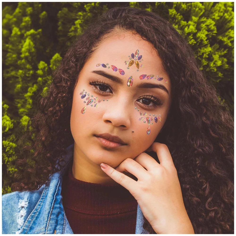 Star Face Gems Pack applied on a person's face, with a denim jacket and burgundy turtleneck in a lush outdoor setting.