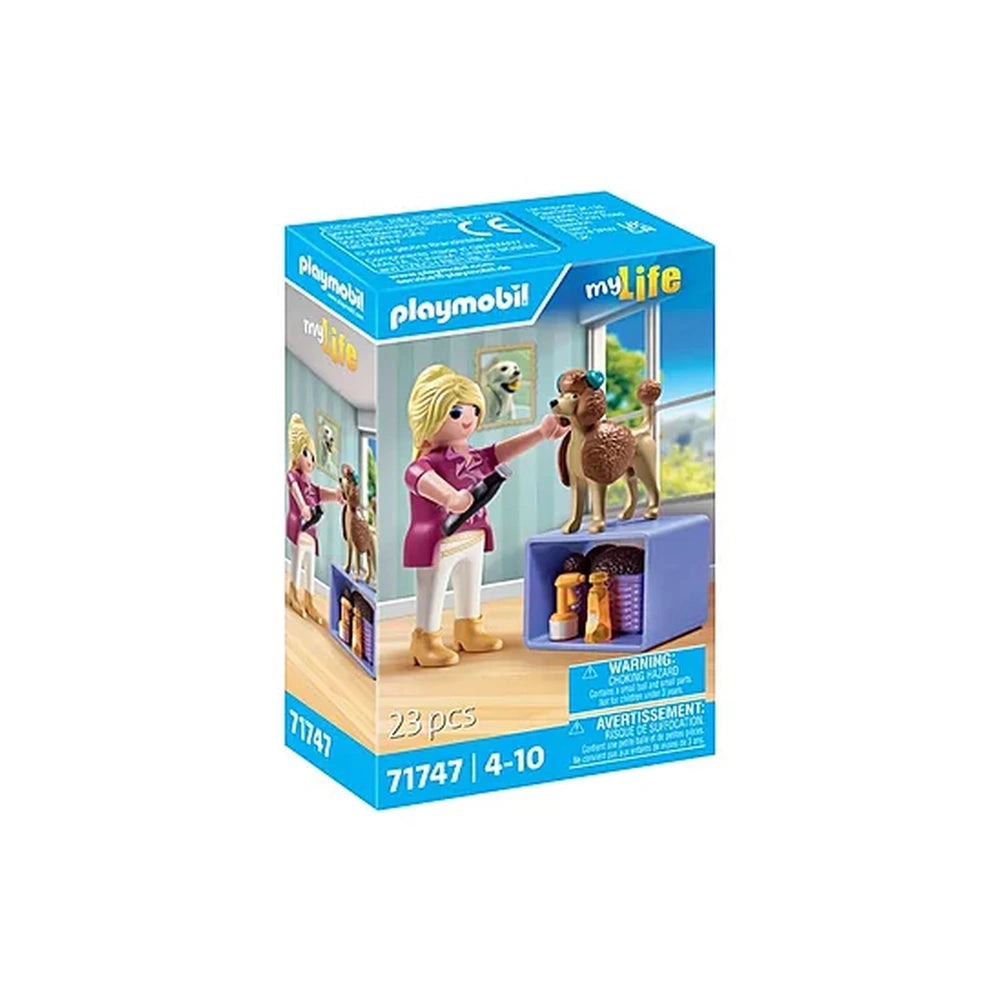 Playmobil Dog-Groomer toy playset featuring a blonde female figure in pink shirt, holding a brown dog by a blue dog house.