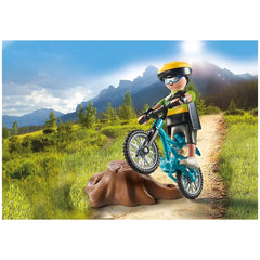 PLAYMOBIL Mountain Biker toy playset features a child in a yellow helmet riding a black bicycle in a mountainous landscape.