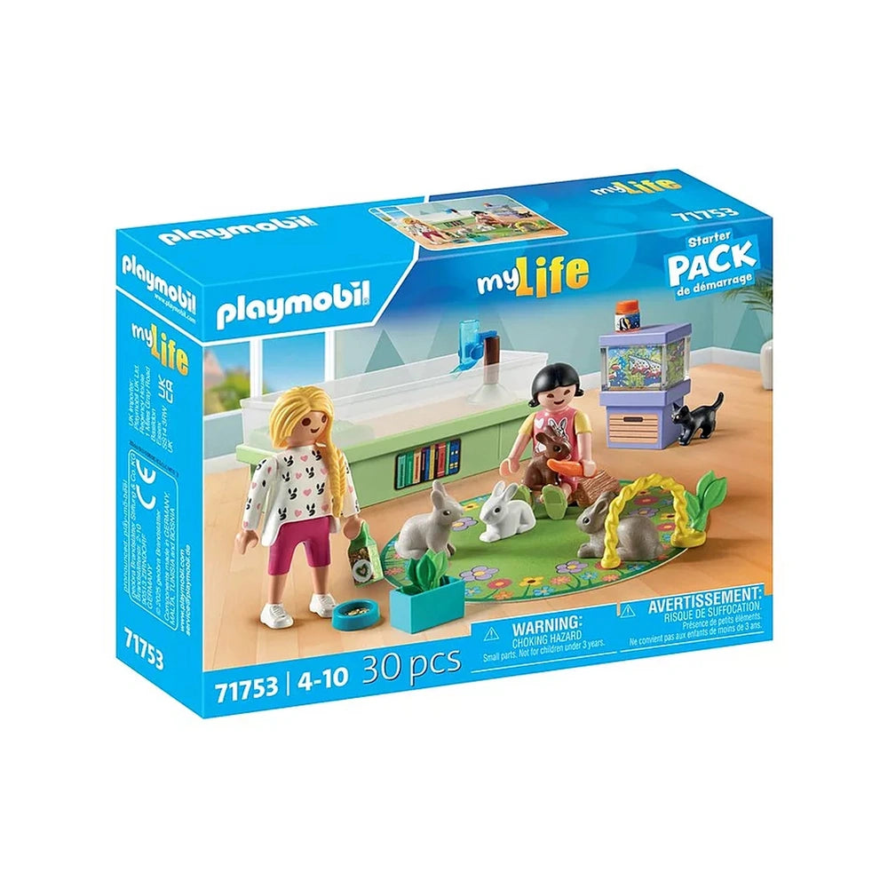 Playmobil Rabbit Family Playset features two dolls, pets, and various colorful playhouses in a blue cardboard packaging.