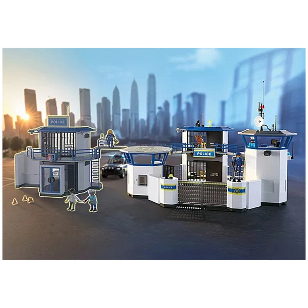 Playmobil Police Command Center features a white building with a blue roof and railings on a gray ground, showcasing a toy pl