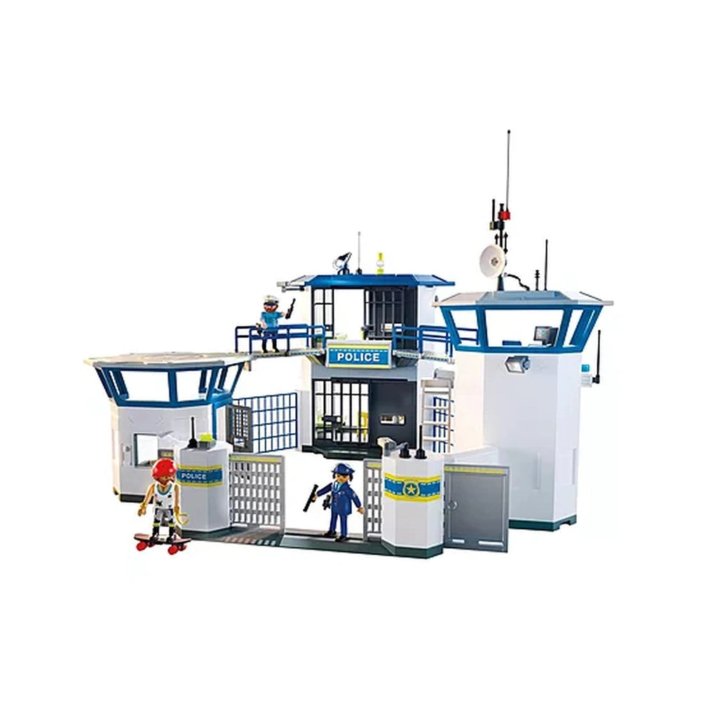 Playmobil Police Command Center features a blue-roofed building, toy figures in blue uniforms, a red skateboard, and police a