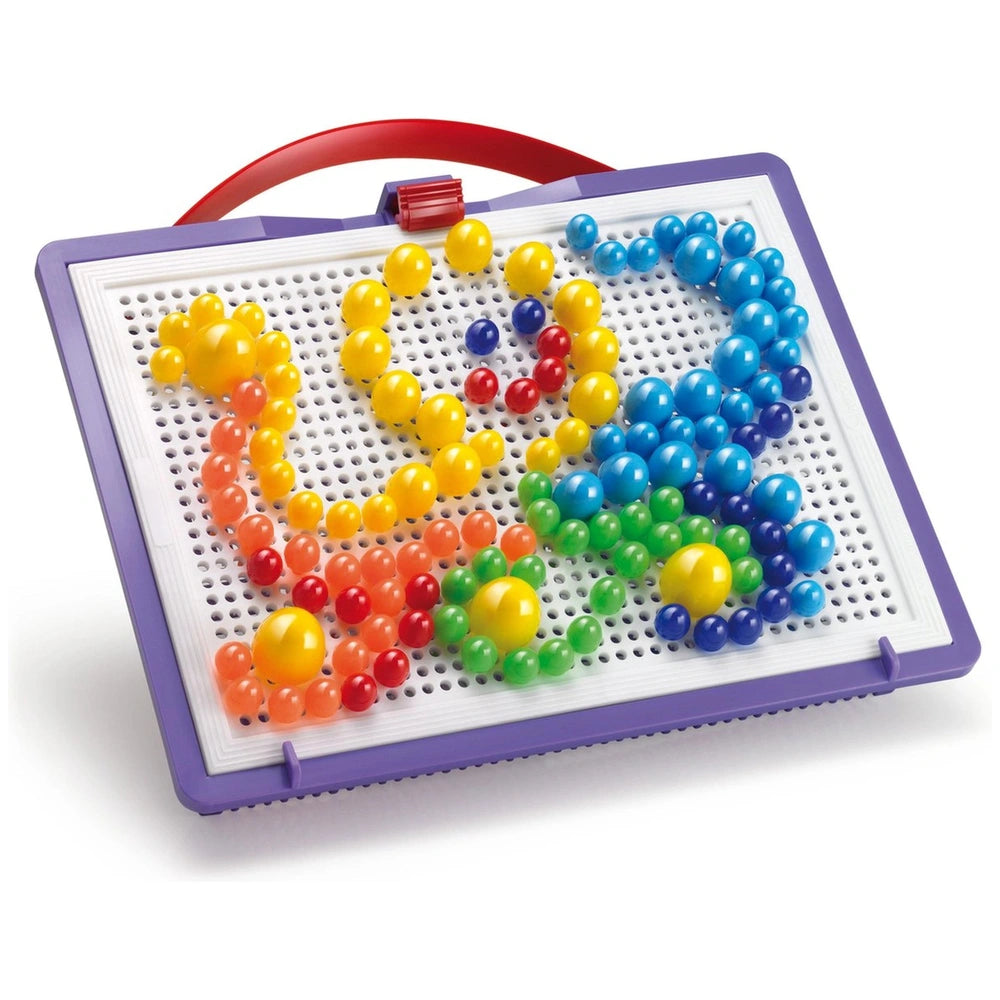 Quercetti FantaColor Tab features a white pegboard with colorful pegs in yellow, red, blue, and green arranged in a purple bo