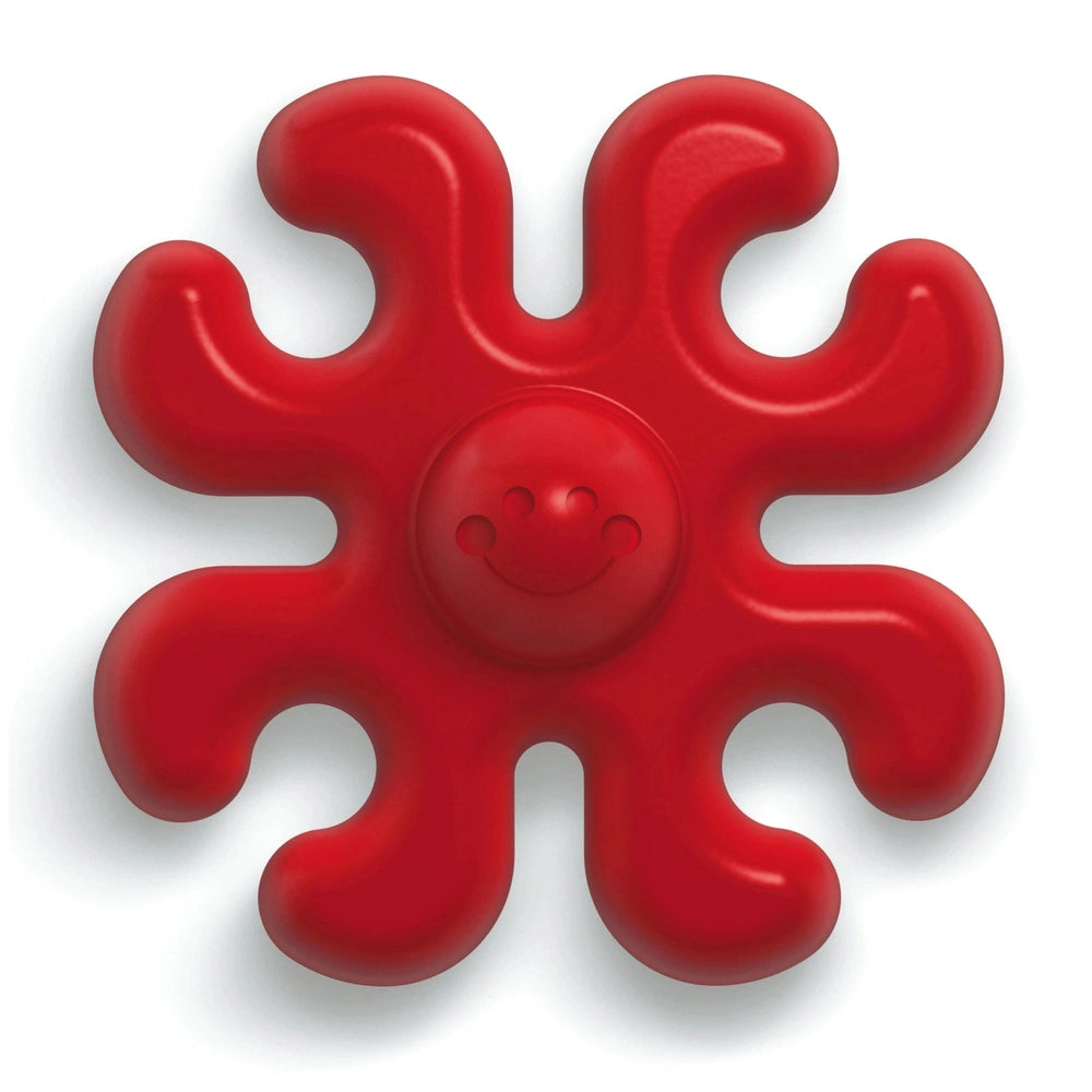 Quercetti Polipetti baby activity toy, solid red with a glossy surface, features eight symmetrical sections and a smiling fac