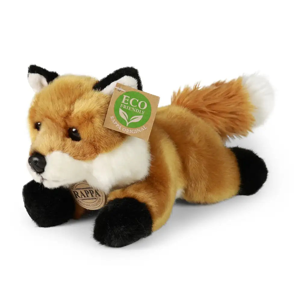 Plush fox toy in orange, white, and black, featuring a soft texture and eco-friendly tag, lying on a white surface.
