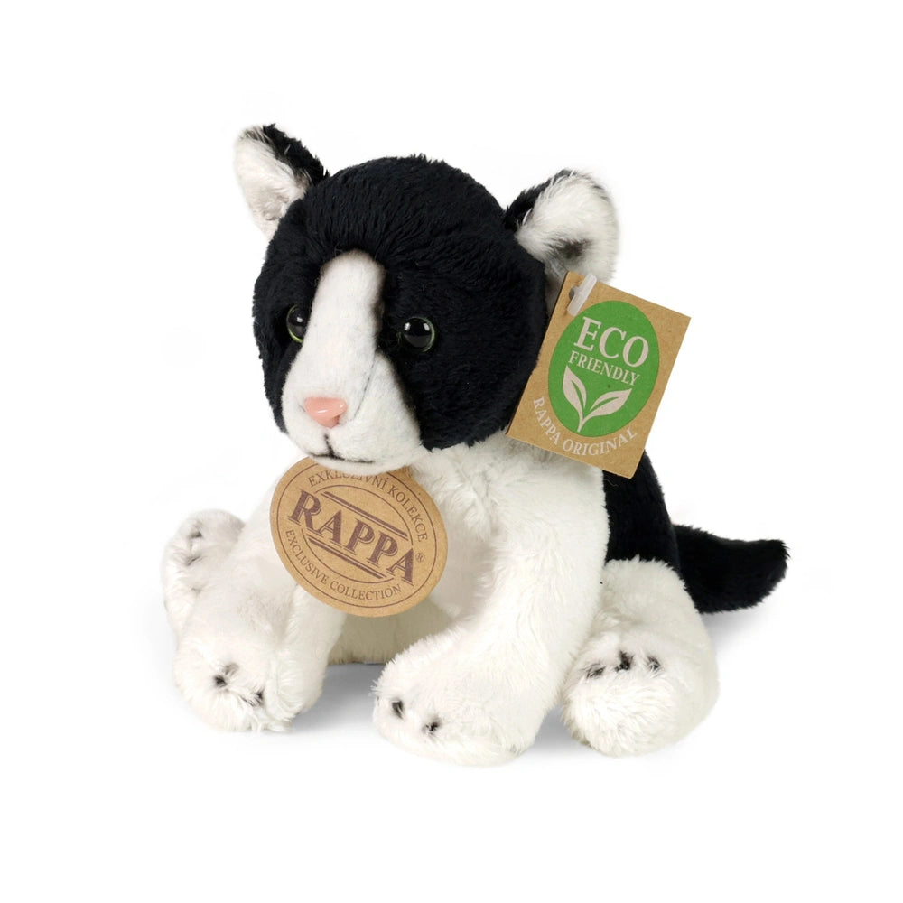 Black and white plush cat with a tag reading "ECO FRIENDLY" and a green leaf symbol, sitting on a plain background.