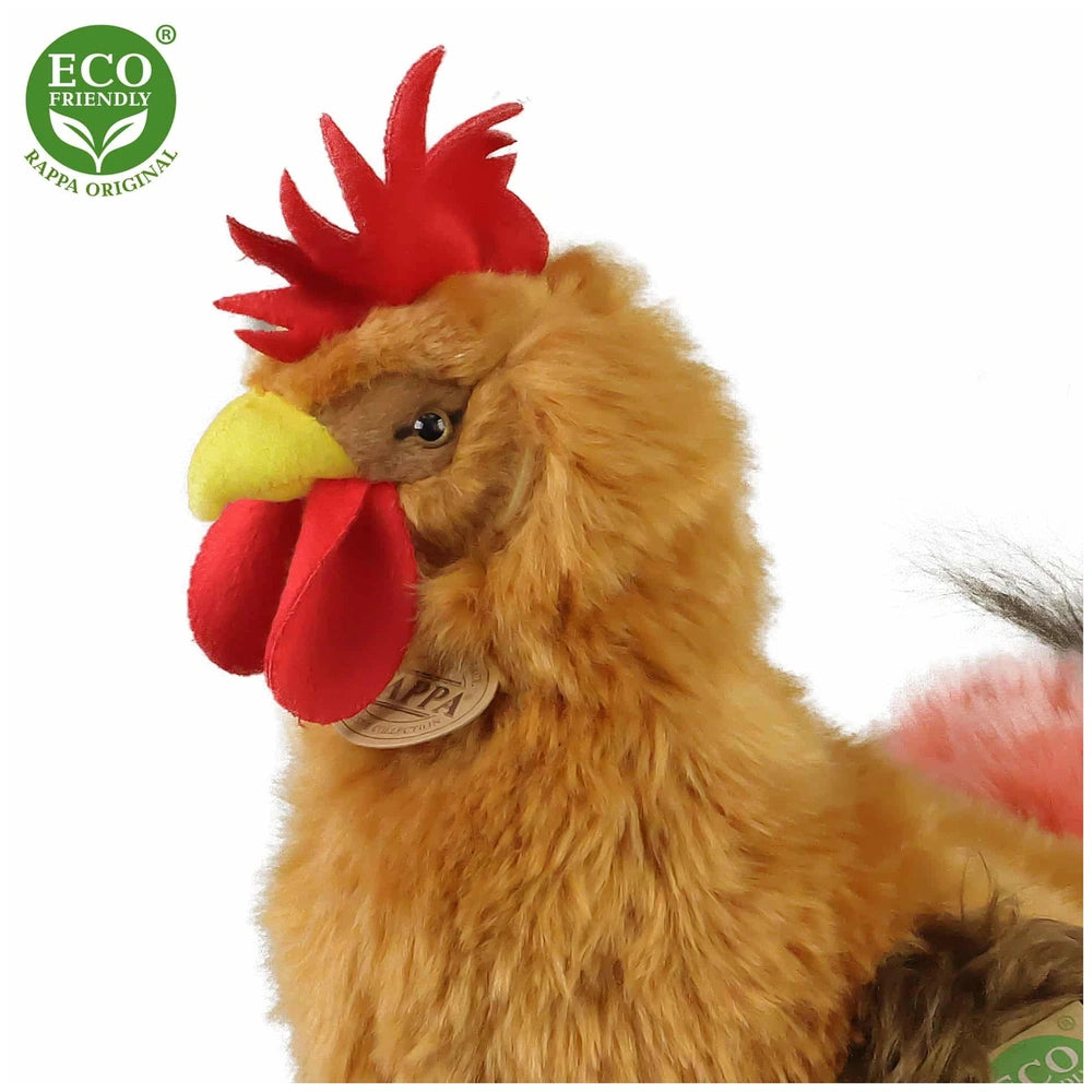 Rappa plush rooster 33 cm in soft yellow fabric with red felt feathers, featuring an eco-friendly tag and logos.